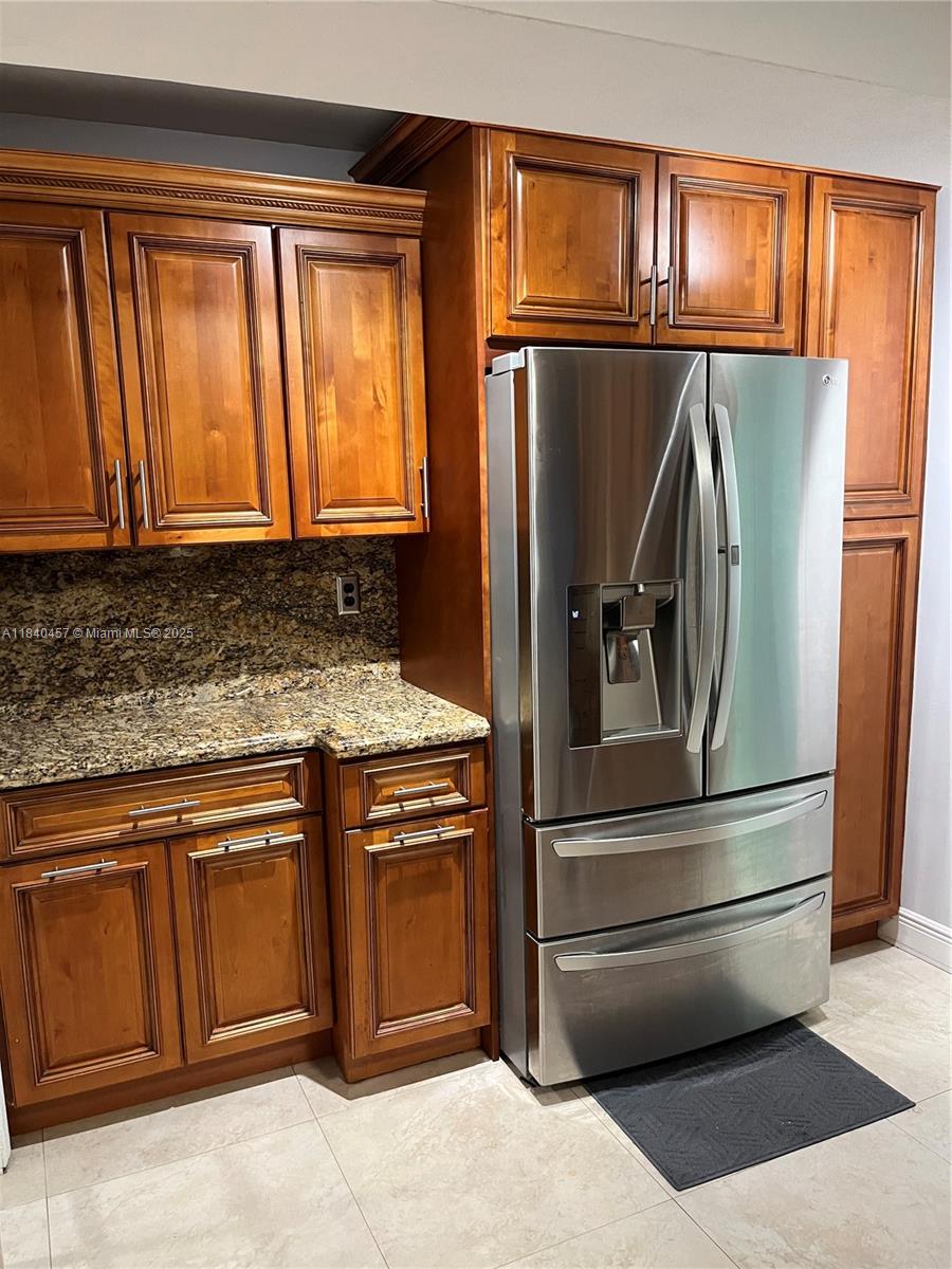 9982 Southwest 162nd Court Miami, FL 33196 - Photo 26 of 97 a kitchen with granite countertop stainless steel appliances and wooden cabinets
