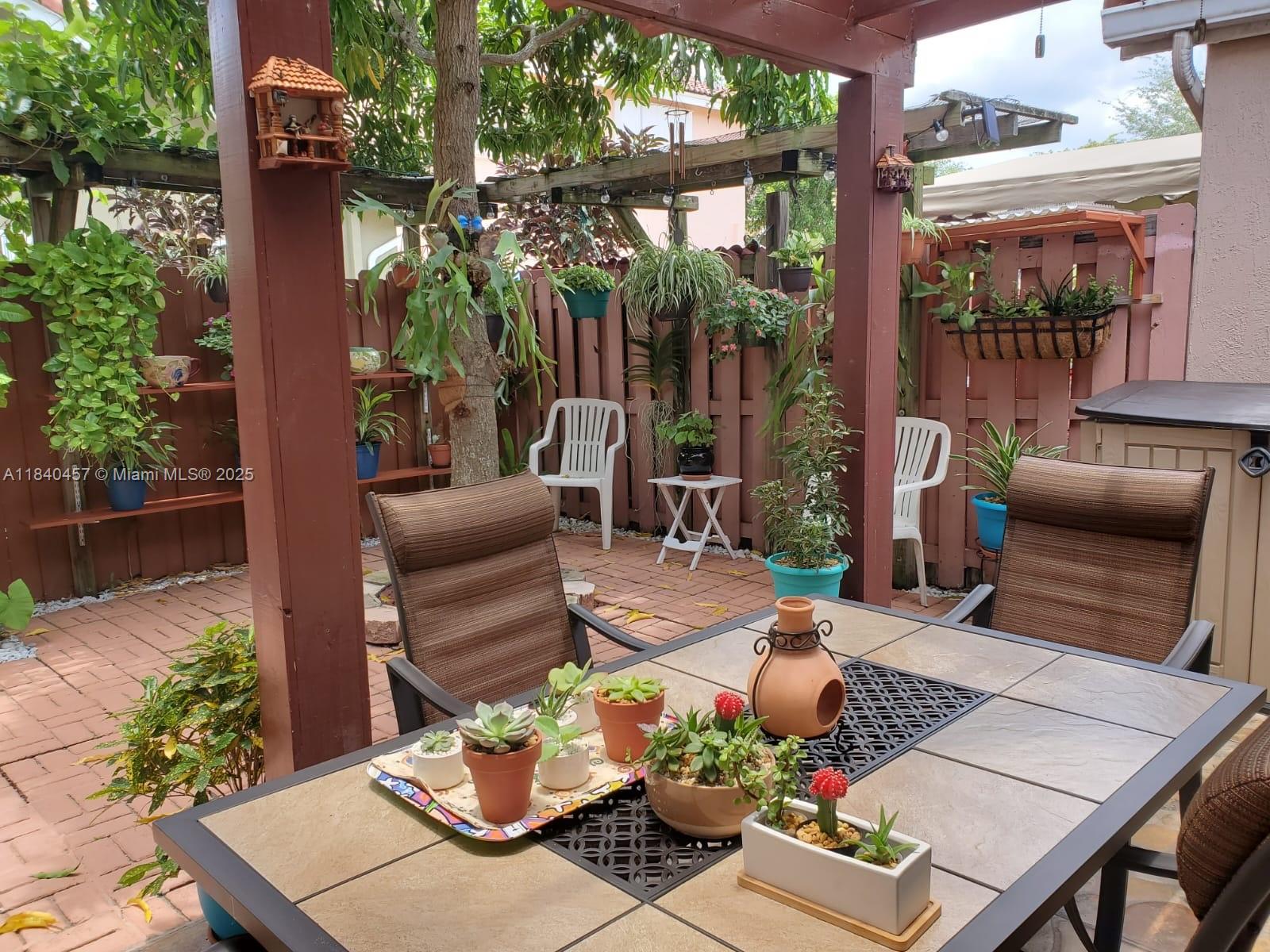 9982 Southwest 162nd Court Miami, FL 33196 - Photo 3 of 97 a view of a patio filled with furniture