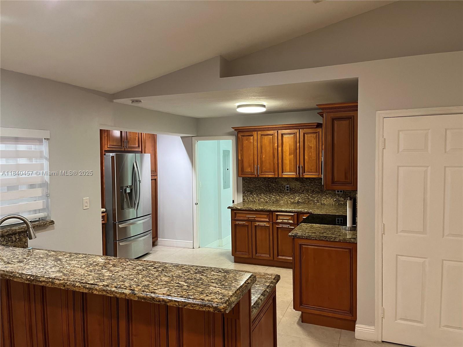 9982 Southwest 162nd Court Miami, FL 33196 - Photo 35 of 97 a kitchen with a stove and a refrigerator