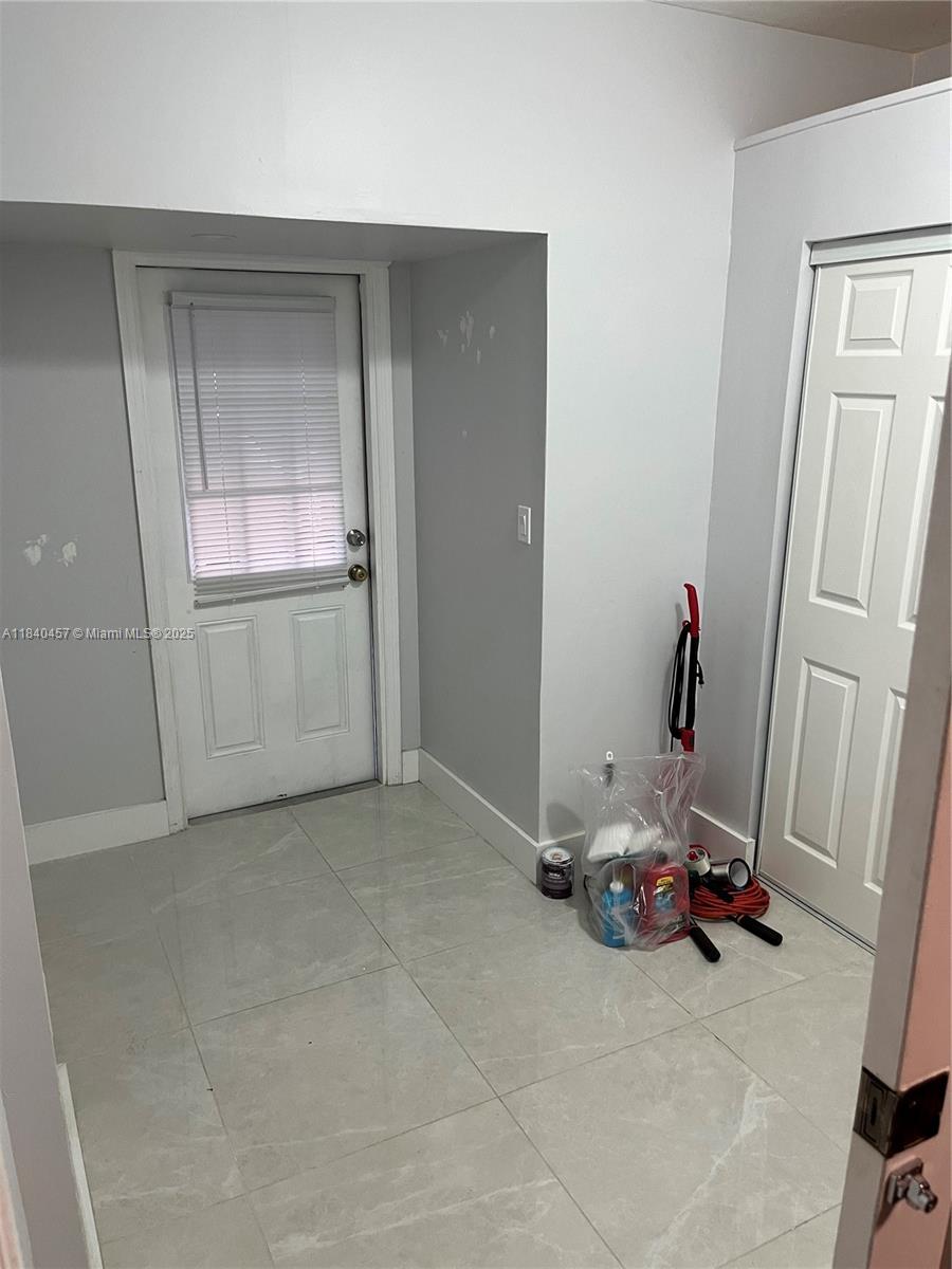 9982 Southwest 162nd Court Miami, FL 33196 - Photo 38 of 97 an empty room with water heater and white cabinet