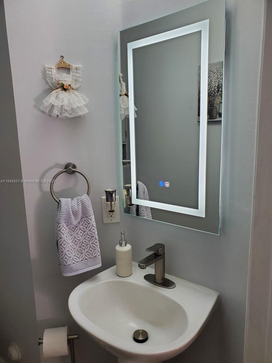 9982 Southwest 162nd Court Miami, FL 33196 - Photo 41 of 97 a bathroom with a sink and a mirror