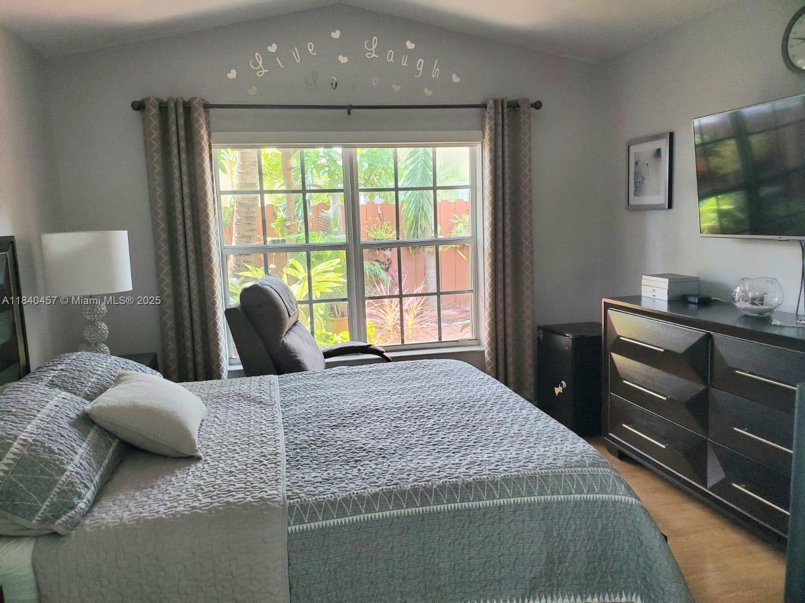 9982 Southwest 162nd Court Miami, FL 33196 - Photo 43 of 97 a bedroom with a bed and wooden floor