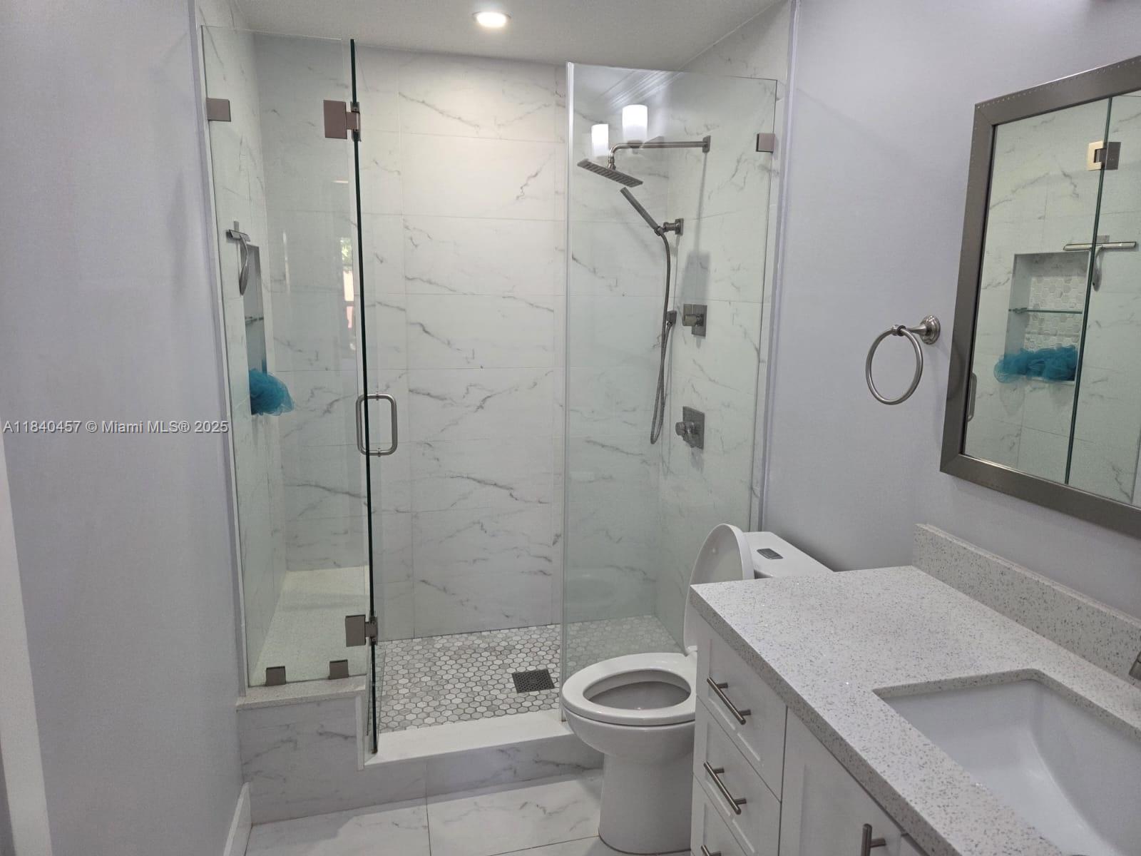 9982 Southwest 162nd Court Miami, FL 33196 - Photo 51 of 97 a bathroom with a shower a toilet and a sink