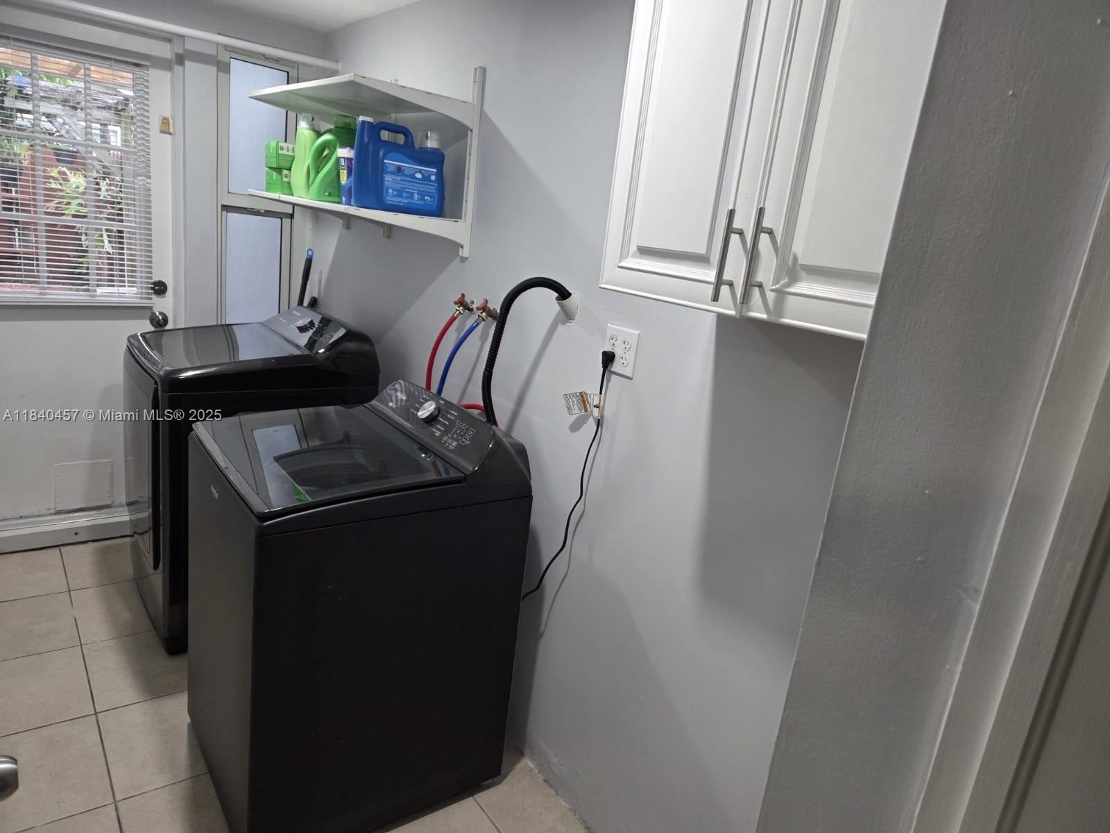 9982 Southwest 162nd Court Miami, FL 33196 - Photo 55 of 97 a view of walk in closet with window and furniture