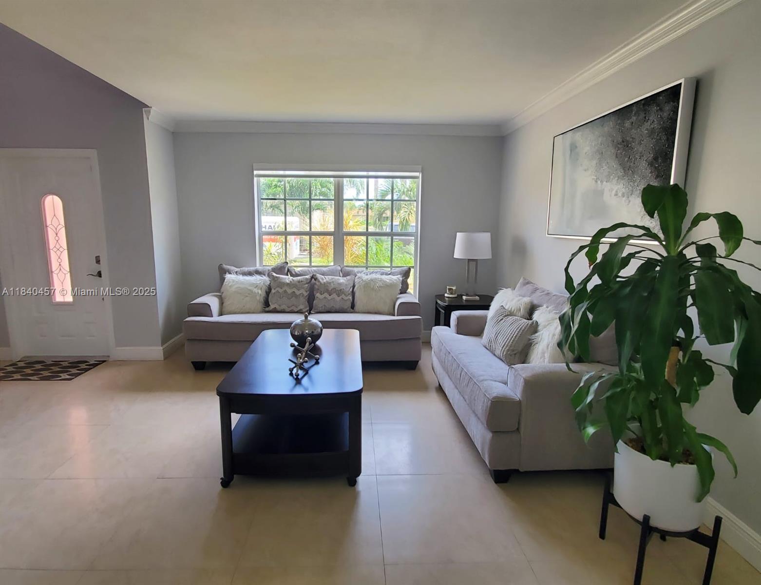 9982 Southwest 162nd Court Miami, FL 33196 - Photo 9 of 97 a living room with furniture and a potted plant