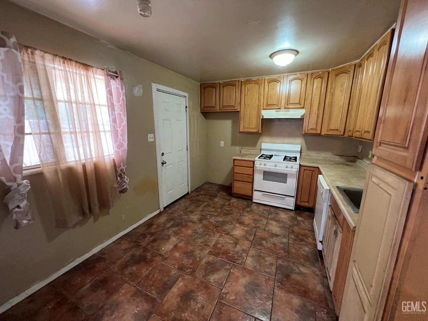 Undisclosed Address Bakersfield, CA 93306 - Photo 11 of 33 a kitchen with a refrigerator and a stove