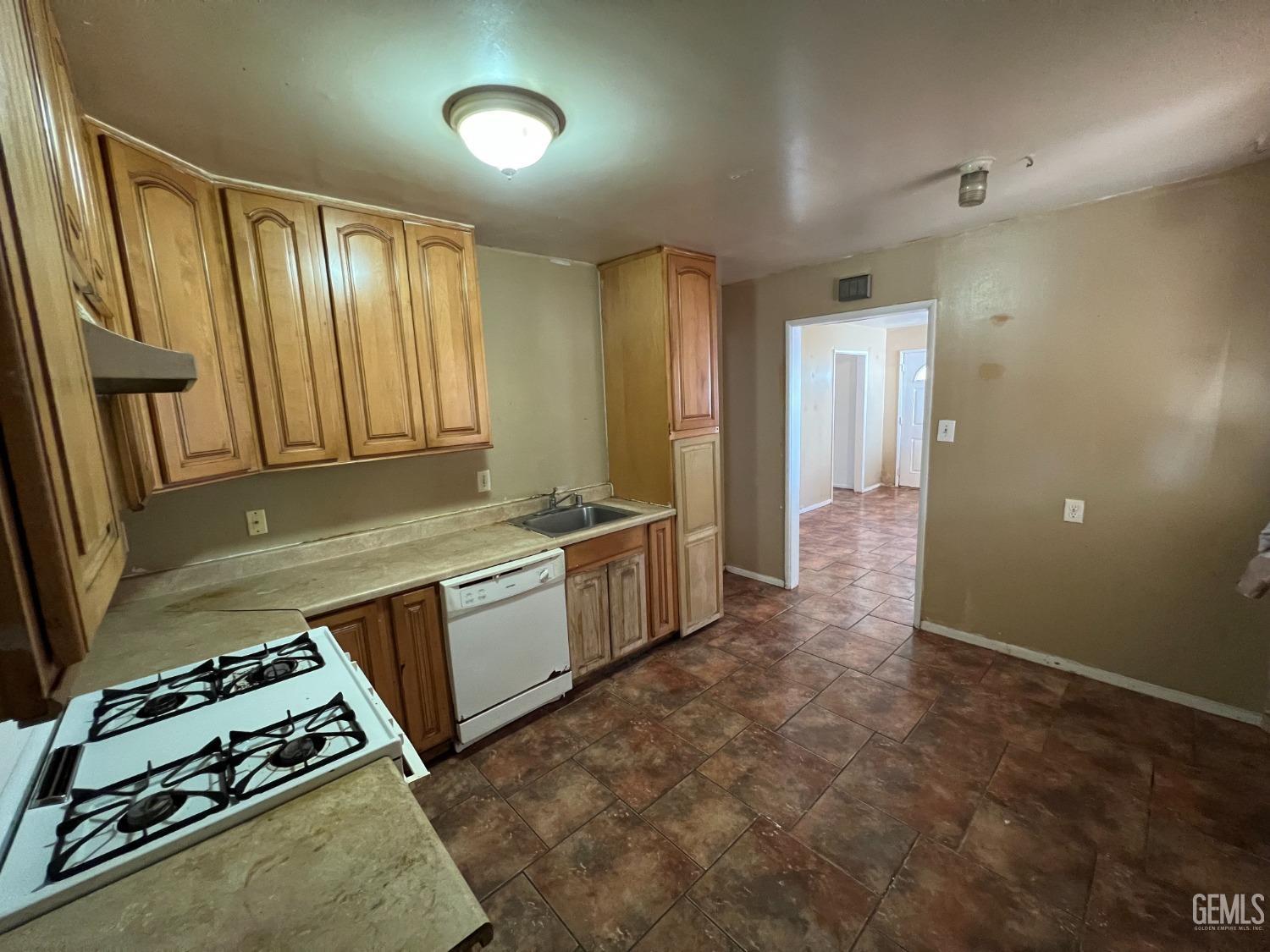 Undisclosed Address Bakersfield, CA 93306 - Photo 13 of 33 a kitchen with a stove and a refrigerator
