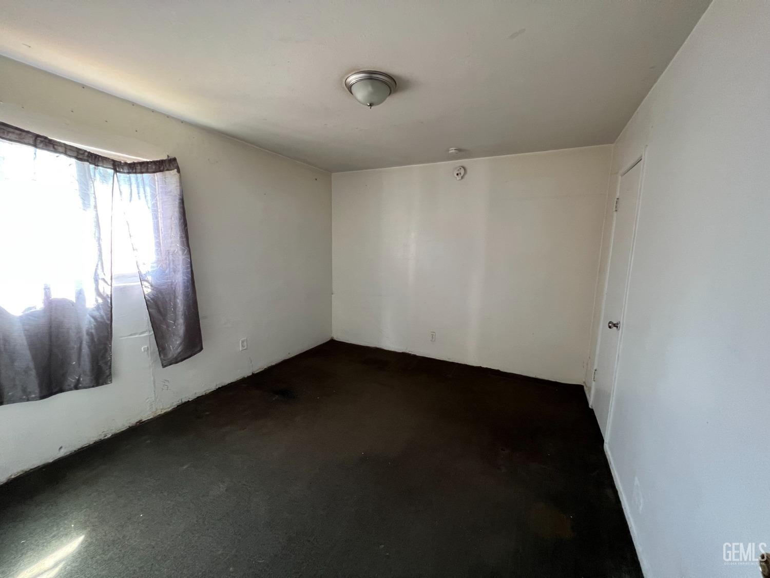 Undisclosed Address Bakersfield, CA 93306 - Photo 17 of 33 a view of an empty room with wooden floor and a window