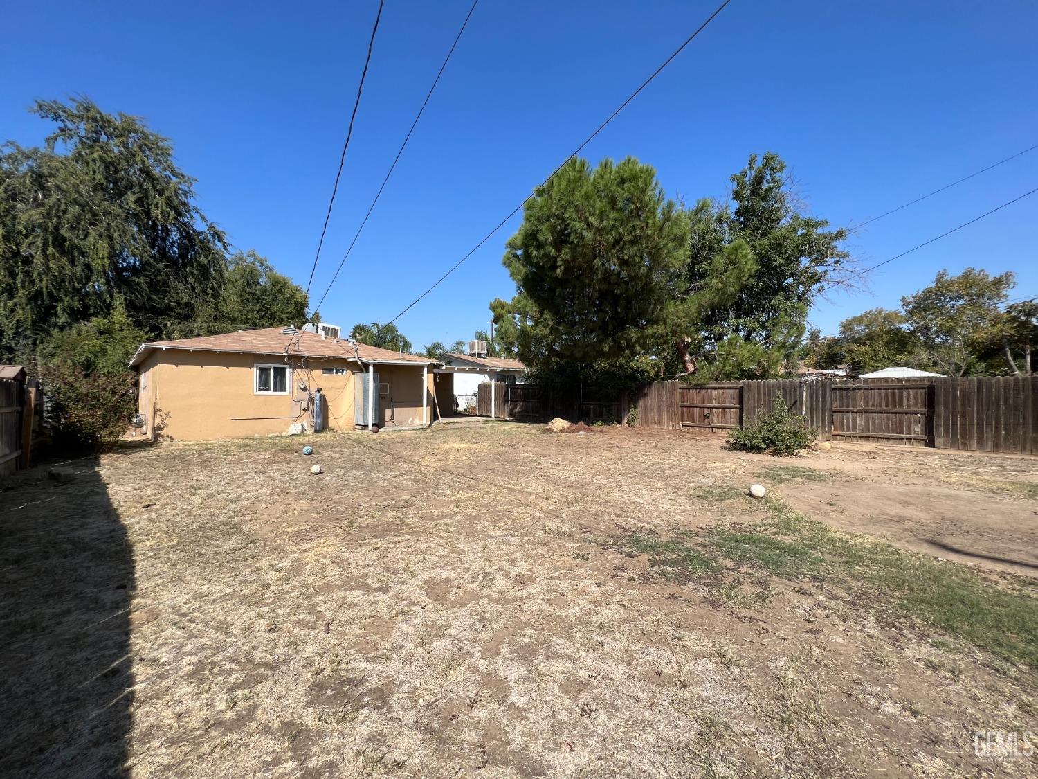 Undisclosed Address Bakersfield, CA 93306 - Photo 25 of 33 a front view of a house with a yard