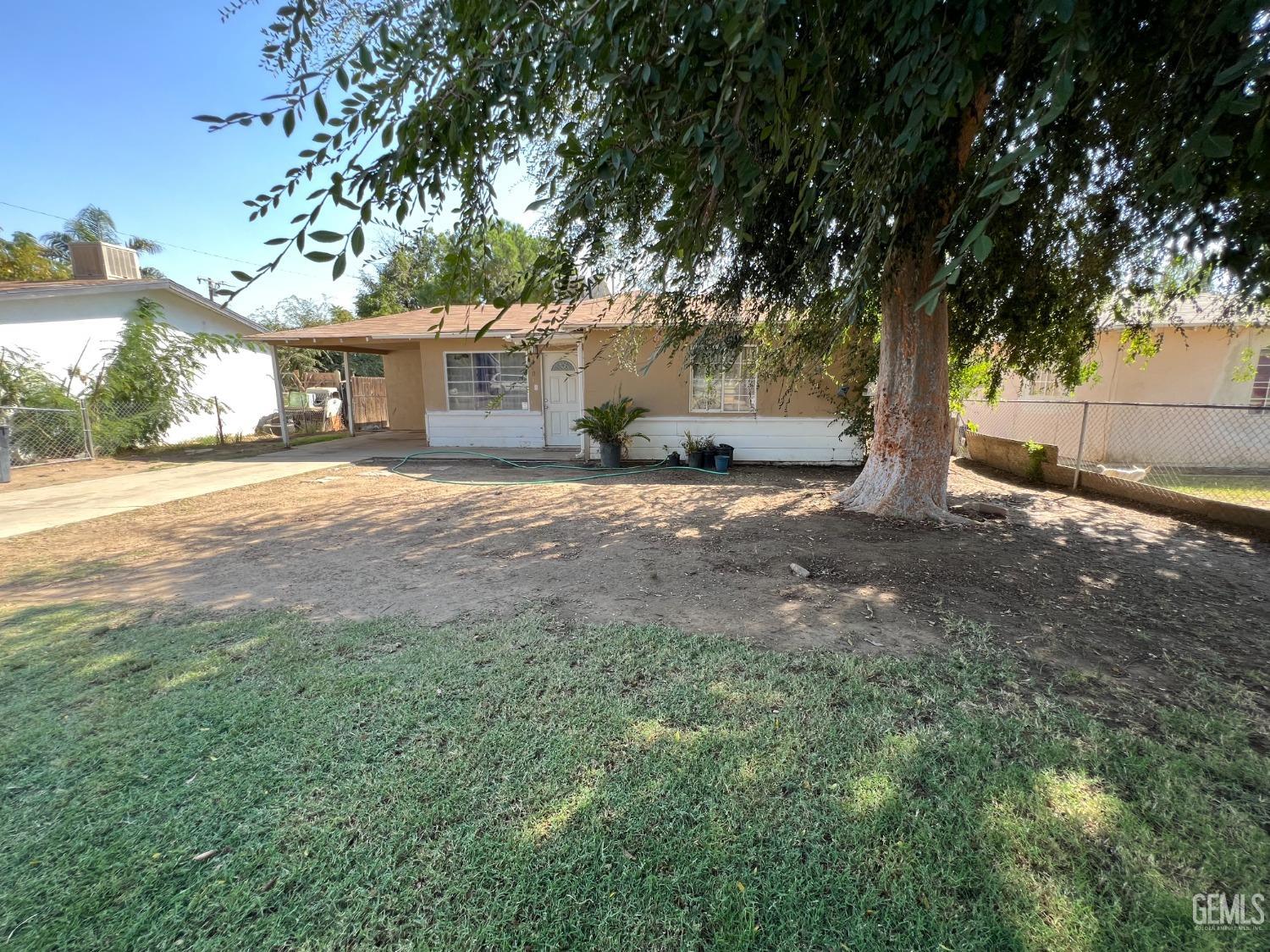 Undisclosed Address Bakersfield, CA 93306 - Photo 3 of 33 a view of a yard with a tree