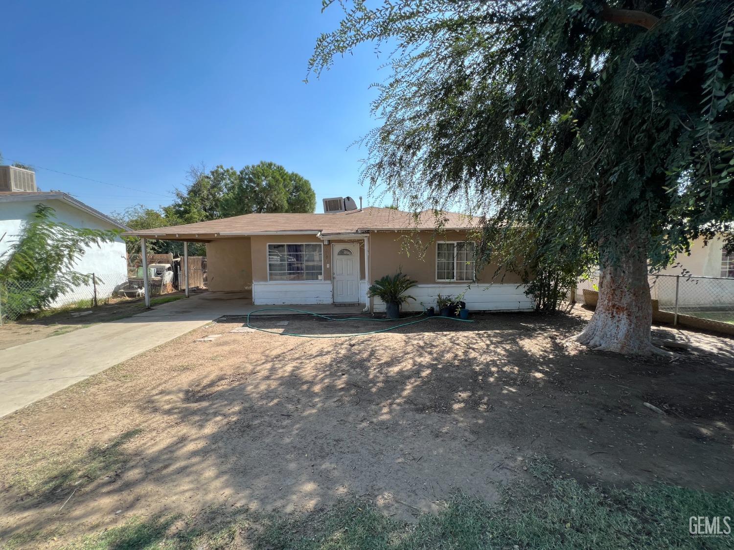 Undisclosed Address Bakersfield, CA 93306 - Photo 5 of 33 a front view of a house with a garden