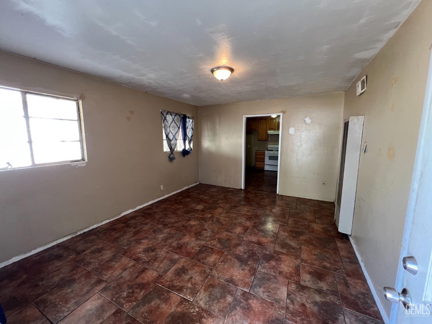 Undisclosed Address Bakersfield, CA 93306 - Photo 7 of 33 an empty room with windows and refrigerator