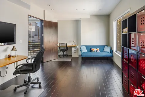 a view of a livingroom with furniture and a flat screen tv