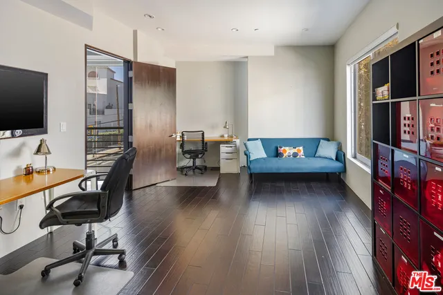 a view of a livingroom with furniture and a flat screen tv