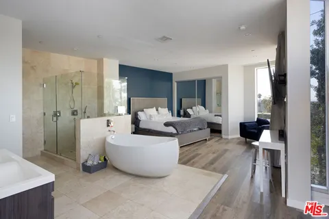 a bathroom with a tub sink and mirror