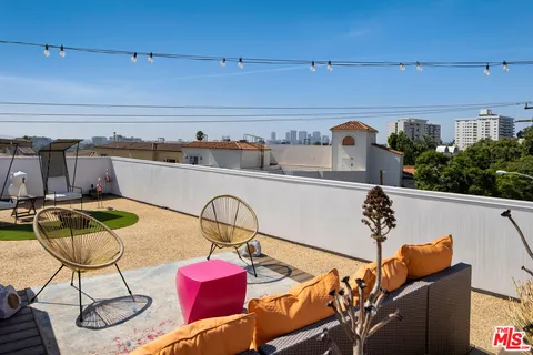 a view of a swimming pool with outdoor seating
