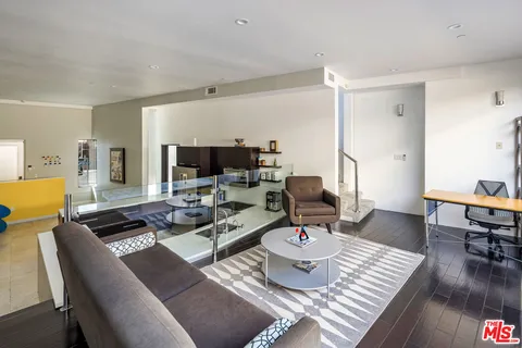 a living room with furniture and a table