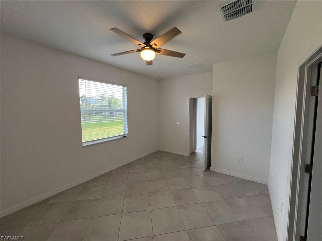 2320 Dragonfruit Way Naples, FL 34120 - Photo 17 of 33 Spare room with light tile patterned floors, baseboards, a ceiling fan, and visible vents