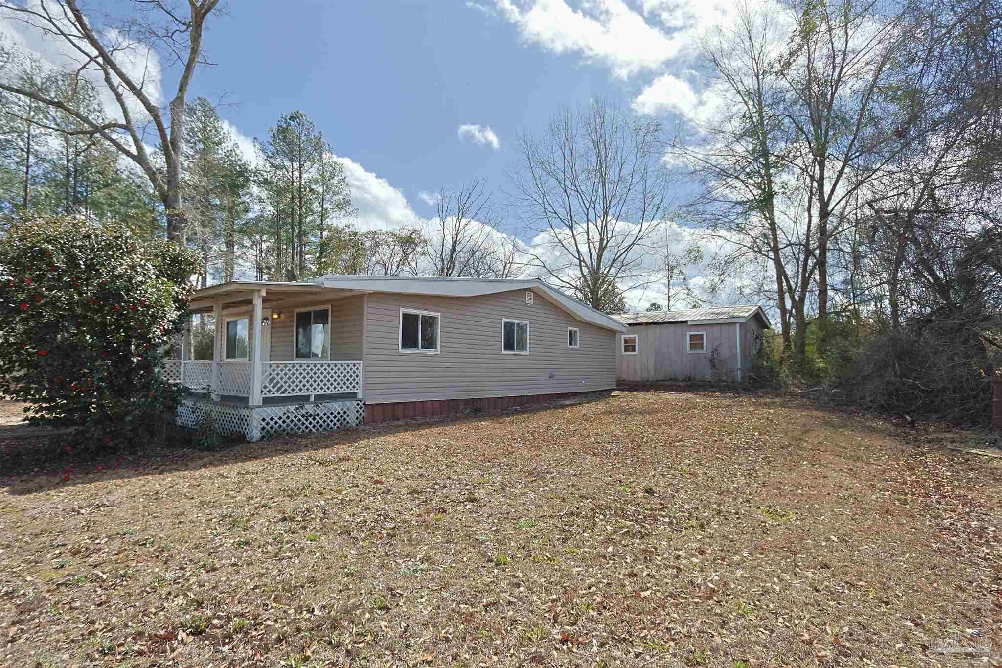 6941 Camp Henderson Road Jay, FL 32565 - Photo 16 of 17 a backyard of a house