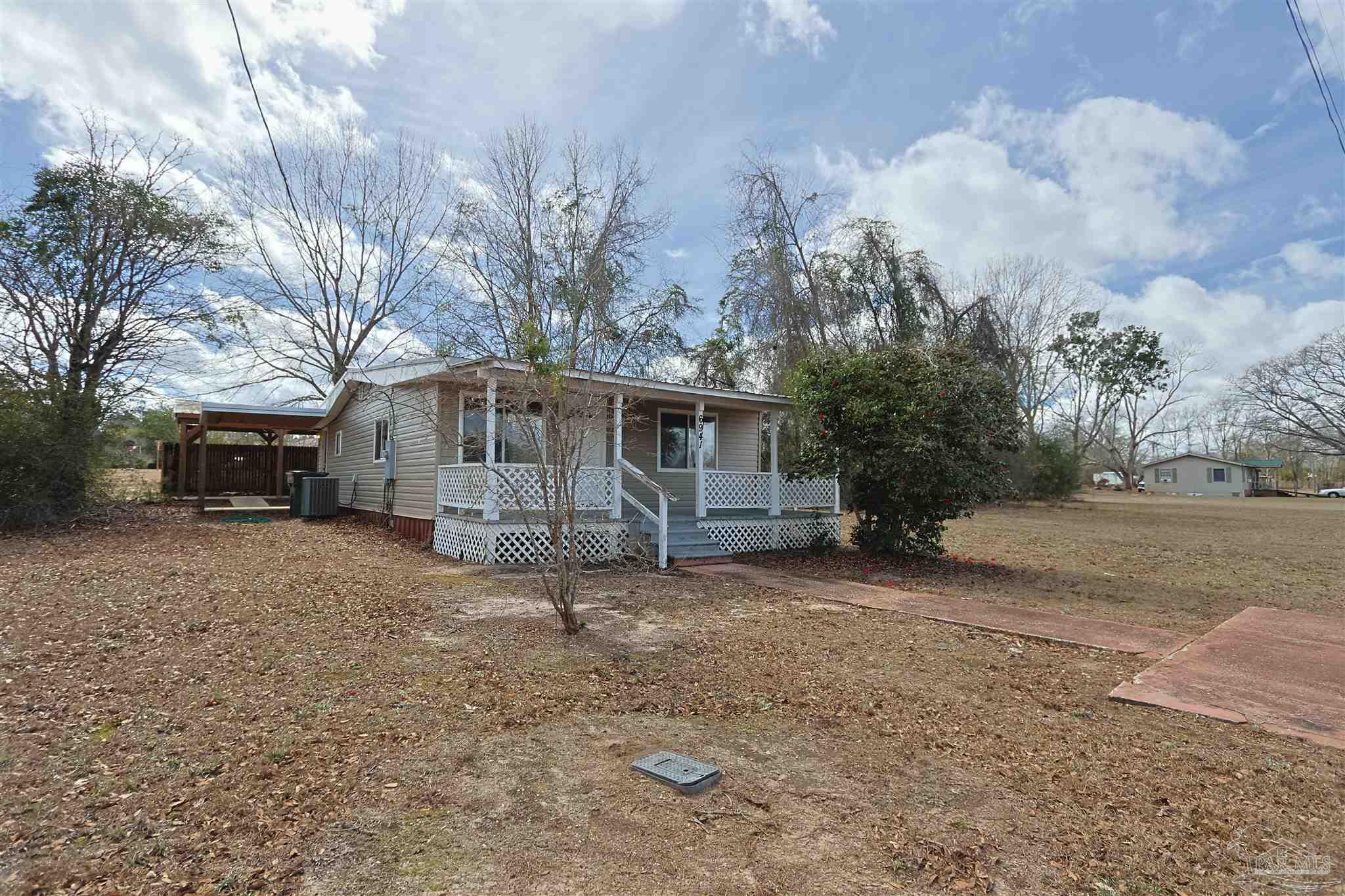 6941 Camp Henderson Road Jay, FL 32565 - Photo 17 of 17 a view of a house with a yard covered in snow