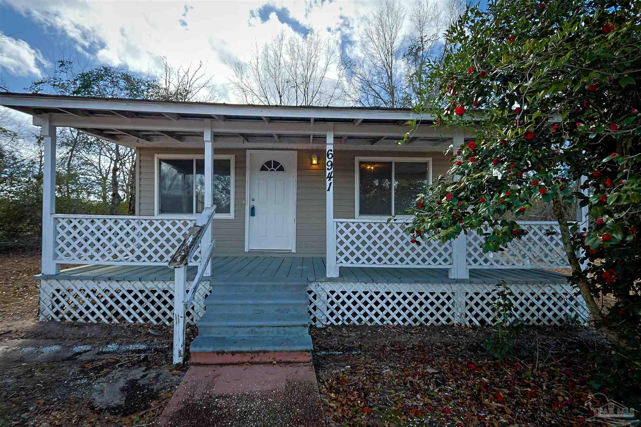 6941 Camp Henderson Road Jay, FL 32565 - Photo 2 of 17 a view of a wooden deck
