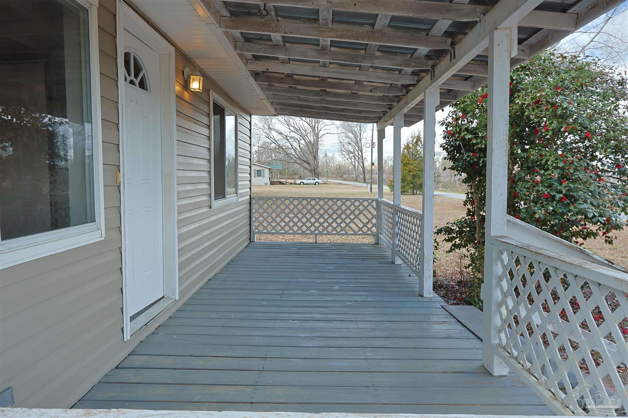 6941 Camp Henderson Road Jay, FL 32565 - Photo 3 of 17 a view of porch with wooden floor