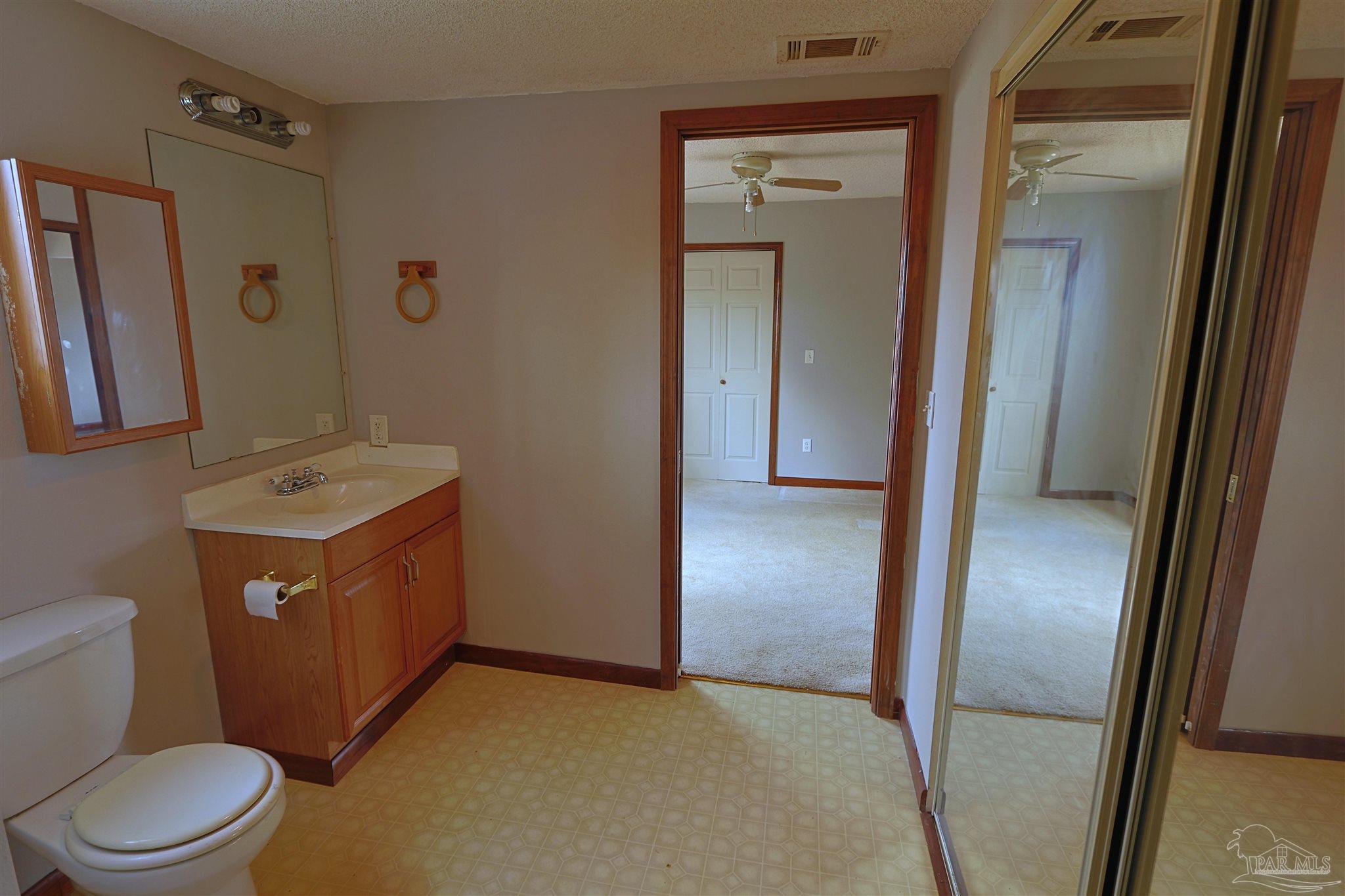 6941 Camp Henderson Road Jay, FL 32565 - Photo 8 of 17 a bathroom with a sink a toilet and shower