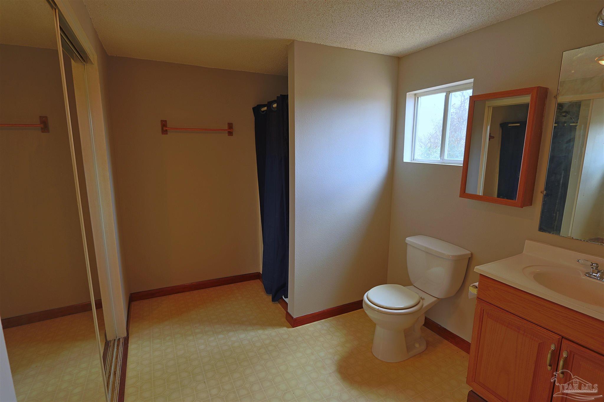 6941 Camp Henderson Road Jay, FL 32565 - Photo 9 of 17 a bathroom with a toilet and a sink