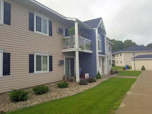 a view of a house with a yard and plants