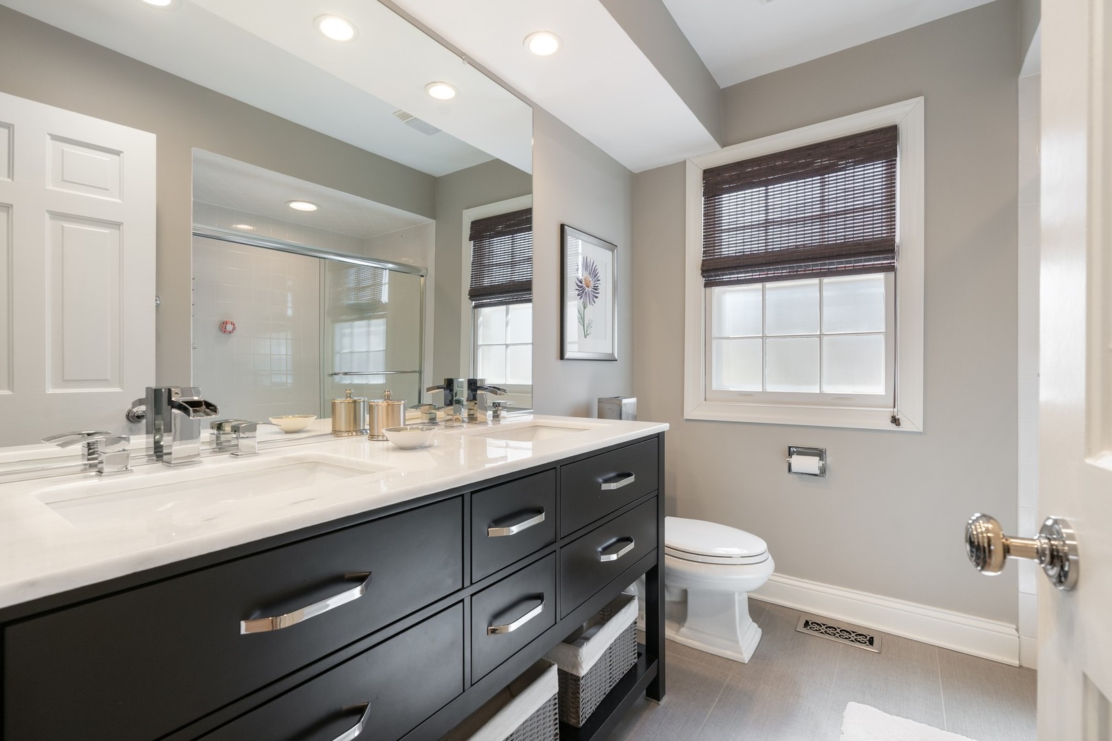 280 Sylvan Road Glencoe, IL 60022 - Photo 27 of 45 a bathroom with a double vanity sink a toilet and a window