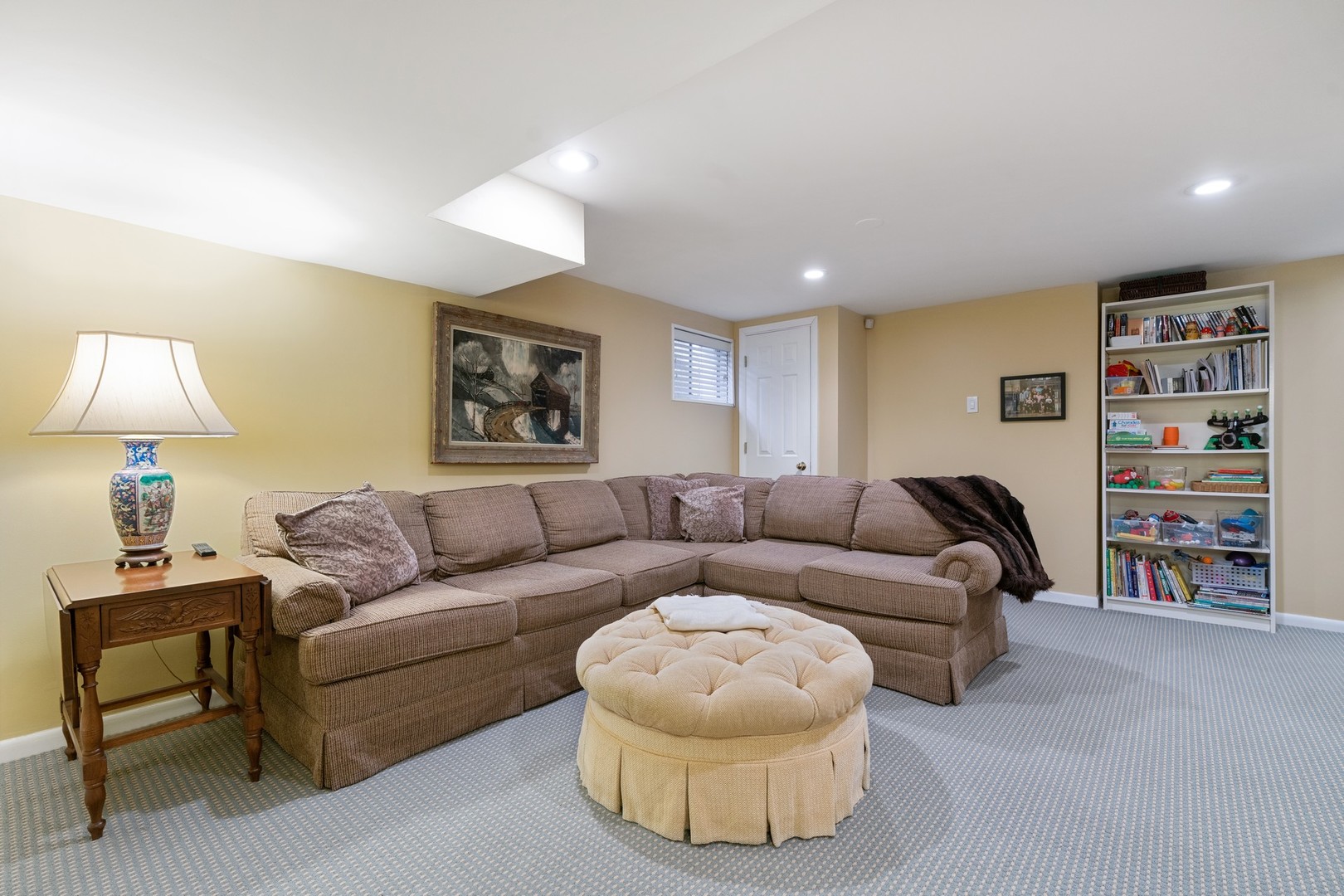 280 Sylvan Road Glencoe, IL 60022 - Photo 30 of 45 a living room with a couch and a bookshelf with wooden floor