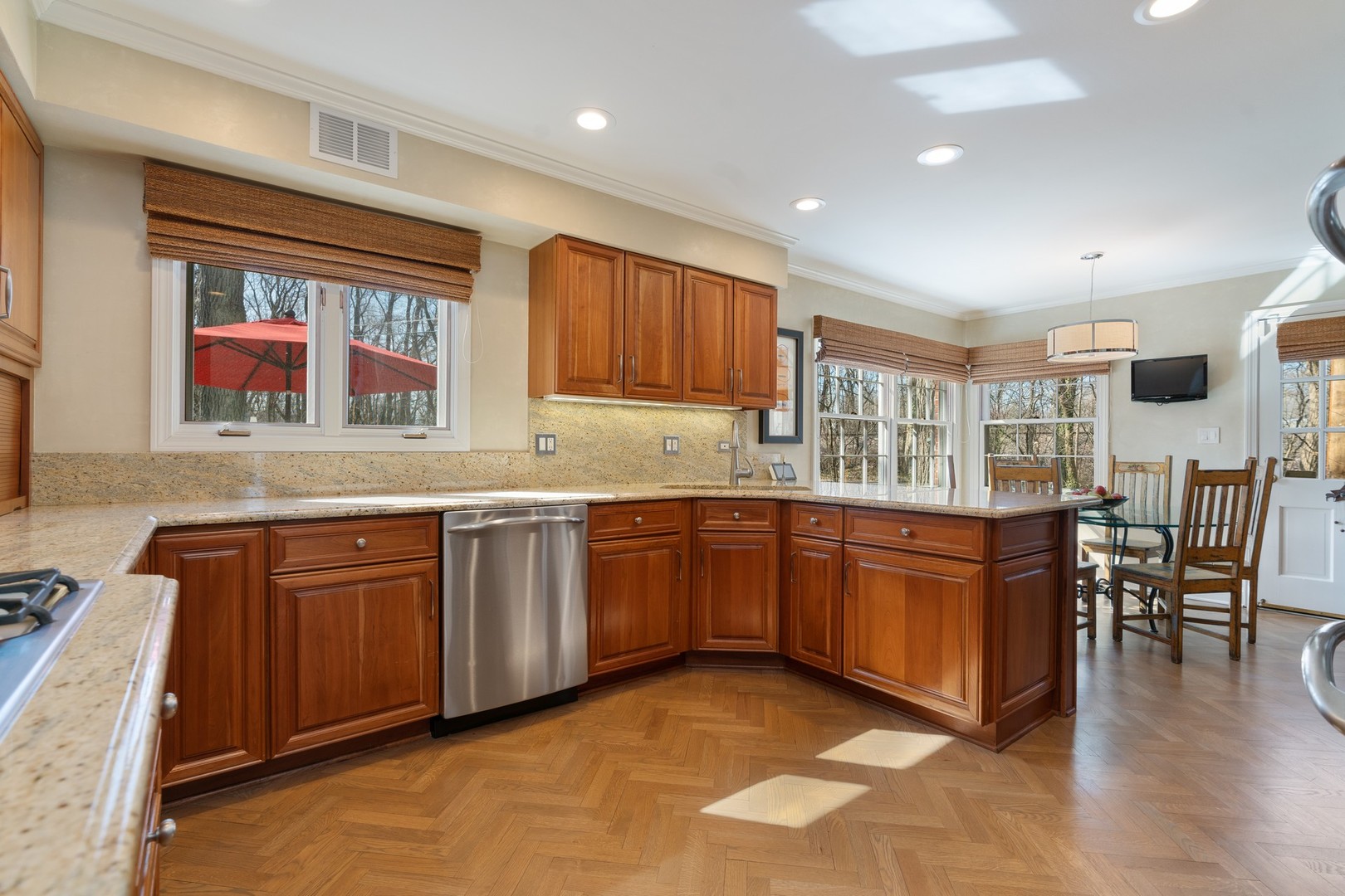 280 Sylvan Road Glencoe, IL 60022 - Photo 8 of 45 a kitchen with granite countertop wooden cabinets a dining table and chairs