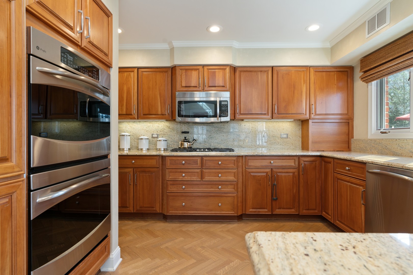 280 Sylvan Road Glencoe, IL 60022 - Photo 10 of 45 a kitchen with stainless steel appliances granite countertop a stove a sink and a microwave