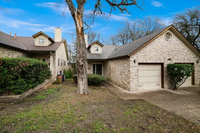 a view of a house with a yard and garage