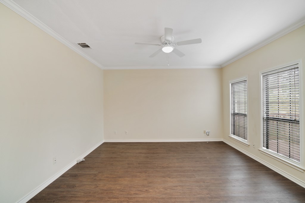 2208 Indian Trail, Unit A Austin, TX 78703 - Photo 12 of 21 an empty room with wooden floor and windows