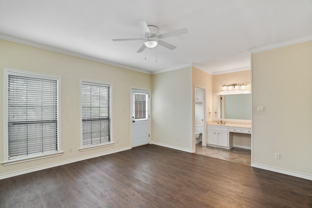 2208 Indian Trail, Unit A Austin, TX 78703 - Photo 13 of 21 an empty room with wooden floor cabinet and windows