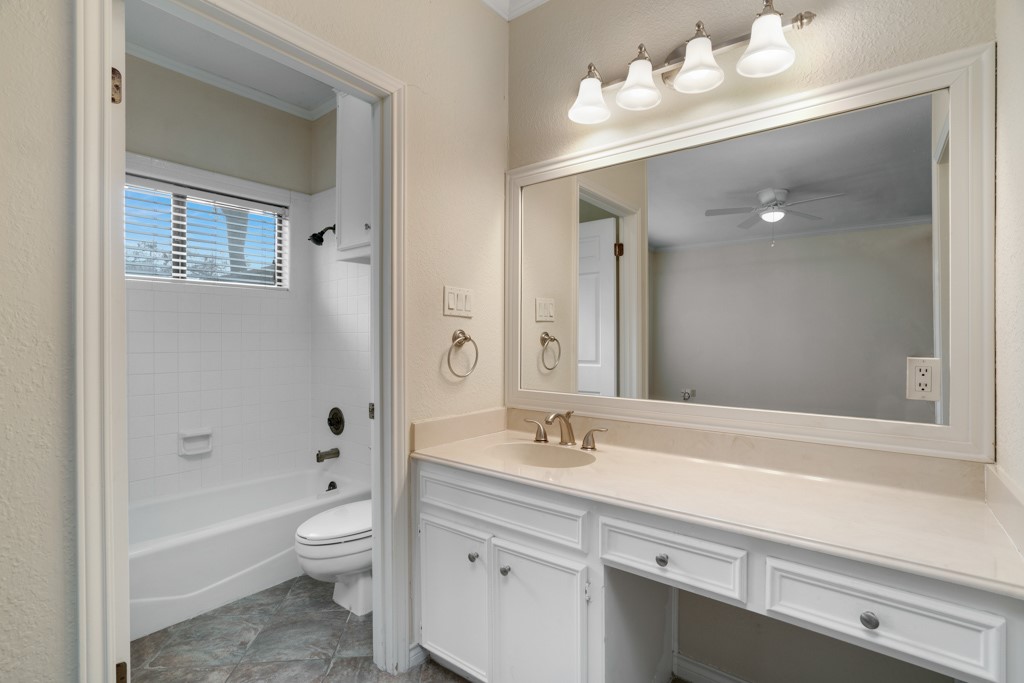 2208 Indian Trail, Unit A Austin, TX 78703 - Photo 14 of 21 a bathroom with a sink a toilet and a mirror