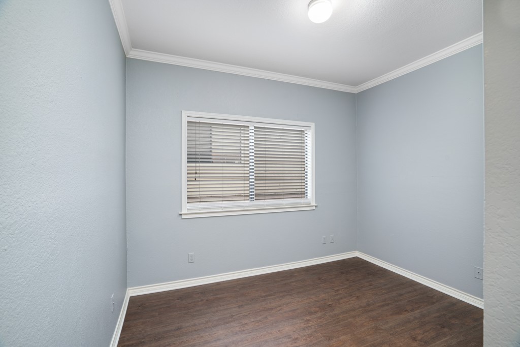 2208 Indian Trail, Unit A Austin, TX 78703 - Photo 15 of 21 a view of an empty room with wooden floor and a window