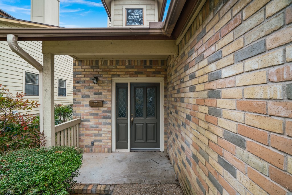 2208 Indian Trail, Unit A Austin, TX 78703 - Photo 2 of 21 a front view of a house with a garden