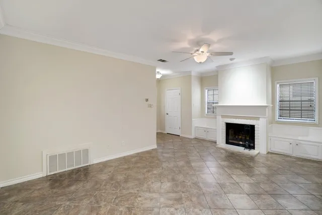 an empty room with a fireplace and fan