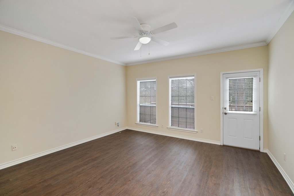 2208 Indian Trail, Unit A Austin, TX 78703 - Photo 10 of 21 a view of an empty room with wooden floor and a window