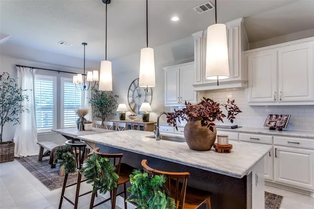 a kitchen with a table and chairs in it
