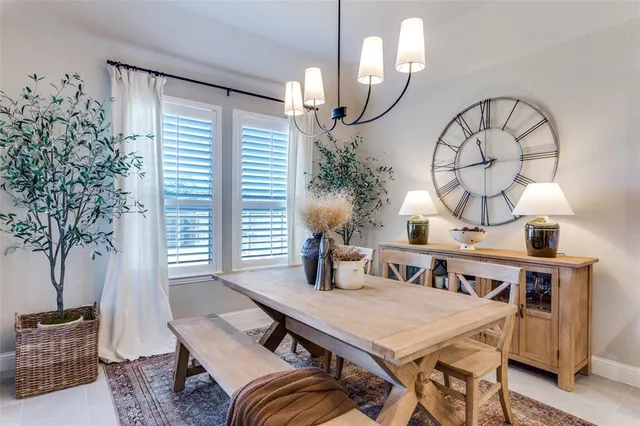a view of a dining room with furniture and a potted plant