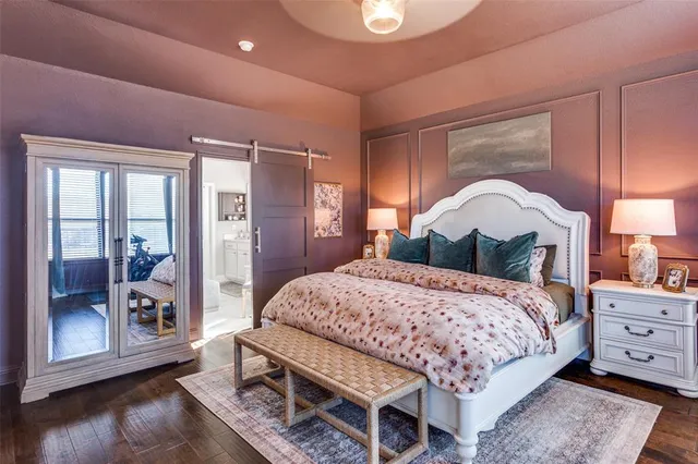 a bedroom with a bed a mirror and a window