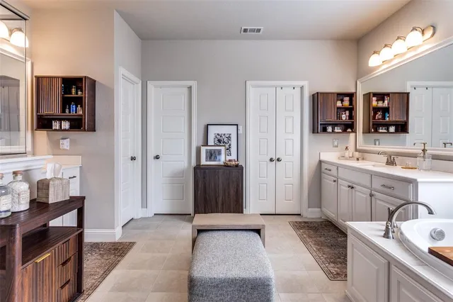 a spacious bathroom with a sink double vanity and a shower
