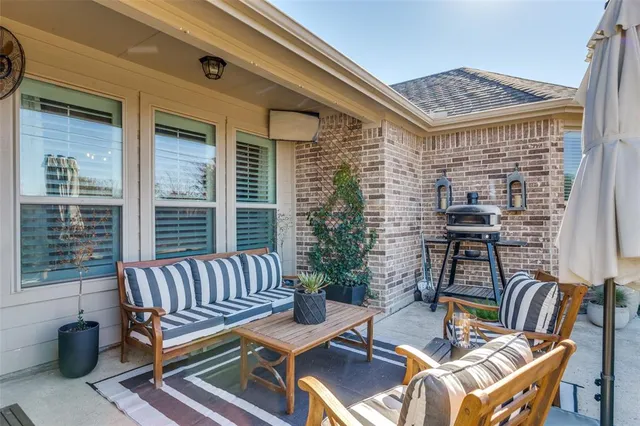 a view of a patio with a table and chairs