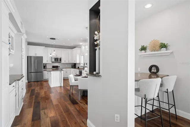 a spacious bedroom with a bed and a chandelier