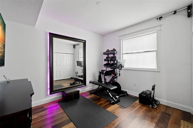 an empty room with wooden floor and window