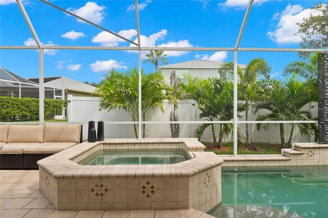 a view of a big yard with potted plants and large tree