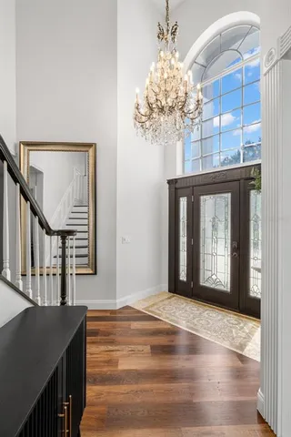 a view of a dining room with furniture and a chandelier